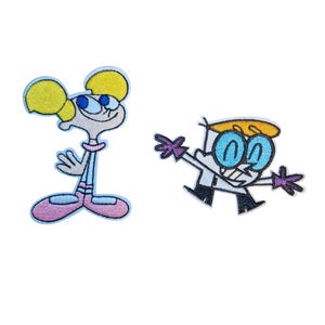 May include: A white ceramic mug with a black handle and the text "But First, Coffee" in a bold, black font. The mug is on a wooden surface. The mug is approximately 10 cm tall.