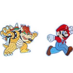 May include: Two embroidered patches featuring iconic video game characters. One patch depicts a yellow, orange, and green Bowser with a spiked shell. The second patch shows a running character wearing a red hat, red shirt, and blue overalls.