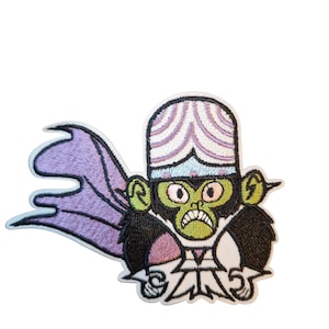 May include: Embroidered patch of a cartoon character with a green face, black fur, and a purple cape. The character wears a white and purple striped hat and a white outfit with a pink chest. The patch has a white border.