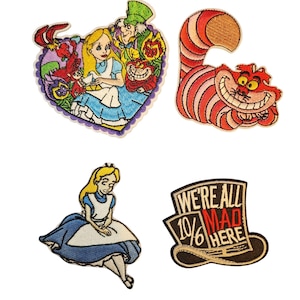 May include: A set of four embroidered patches featuring characters and text from Alice in Wonderland. One heart-shaped patch shows Alice, the Mad Hatter, and the Cheshire Cat. Another is a pink and orange striped Cheshire Cat, a seated Alice, and a top hat with the text WE'RE ALL MAD HERE and 10/6.