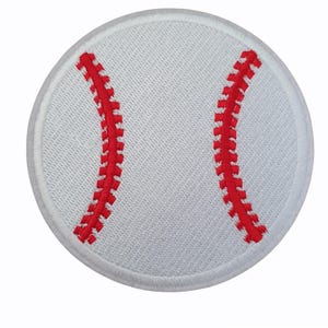 May include: A white baseball patch with red stitching. The round patch features the classic baseball design with two curved red stitch lines. The background is plain white.