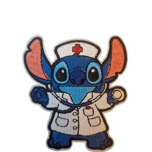 May include: Embroidered patch featuring a blue cartoon character in a nurse's uniform. The character has large eyes, a white hat with a red cross, and a stethoscope. The patch is outlined in black and has a white background.