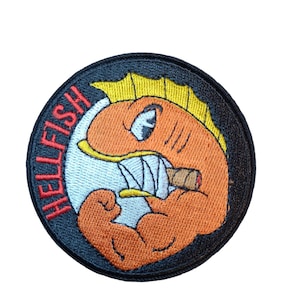 May include: Embroidered patch featuring a cartoon fish with orange scales, yellow fins, and a cigar in its mouth. The fish has a muscular arm and is set against a white and black background. The word "HELLFISH" is written in red.