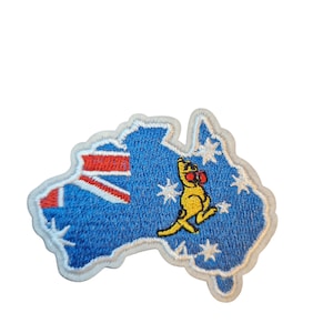 May include: Embroidered patch in the shape of Australia, featuring the Australian flag and a kangaroo wearing boxing gloves. The patch is blue with white stars and a white border. The kangaroo is yellow with red boxing gloves.