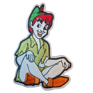 May include: Embroidered patch of Peter Pan from the Disney film. The patch shows Peter Pan in his green outfit, red hair, and orange shoes. The patch has a white border and is designed for application on clothing or accessories. A nostalgic item for fans.