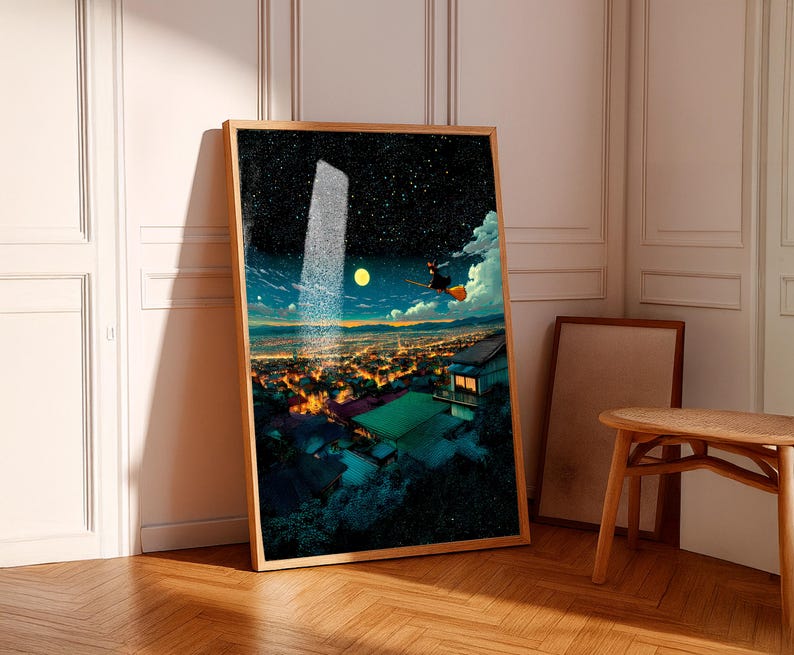 May include: A framed art print depicts a nighttime cityscape with a starry sky, a full moon, and a figure on a broom. The artwork features a wooden frame and is leaning against a white wall. The scene is illuminated by city lights.
