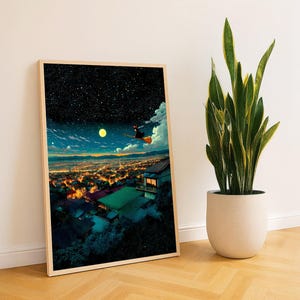 May include: A framed art print depicts a witch flying on a broom over a city at night, under a starry sky and a full moon. The artwork has a warm color palette with a wooden frame. A potted snake plant is next to the framed art print.