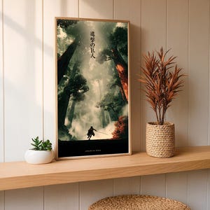 May include: A framed art print featuring a dramatic forest scene with a silhouetted figure. The artwork has a vertical orientation and includes Japanese text at the top and the words "attack on titan" at the bottom. The print is displayed on a wooden shelf.