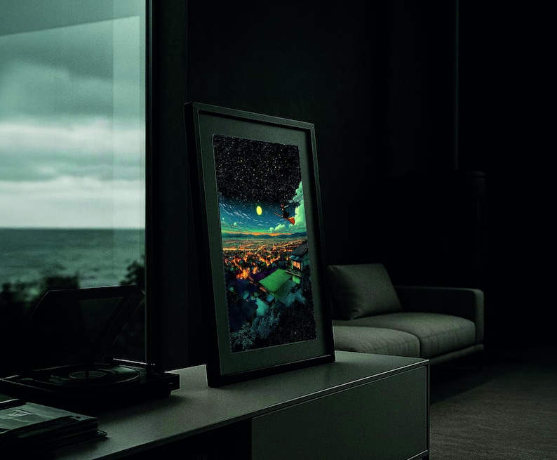 May include: A framed art print featuring a vibrant, colorful cityscape under a starry night sky. The artwork is displayed in a modern, dark-toned room, leaning against a wall. The print's colors contrast with the room's muted tones.