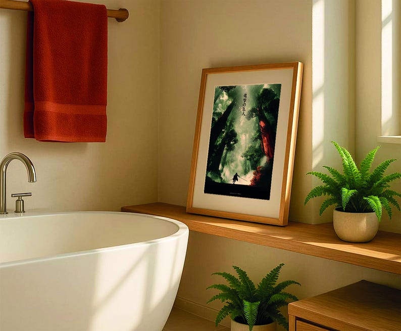 May include: A bathroom scene featuring a framed artwork with Japanese text, a white bathtub, and a rust-colored towel. The artwork depicts a forest scene with a figure. Green plants in white pots add a touch of nature to the room.