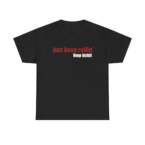 May include: Black t-shirt with the text "just keep rollin' limp bizkit" in red and white. The shirt has a crew neck and short sleeves. The text is centered on the front of the shirt.