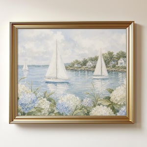 May include: A framed painting featuring three white sailboats on a calm blue body of water. The foreground is filled with clusters of light blue and white hydrangea flowers. In the background, green trees and white houses line the shore.