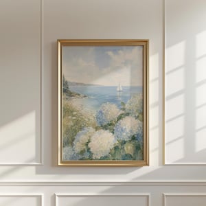 May include: A framed painting depicting a coastal scene with a sailboat on the water, a rocky shoreline, and large clusters of light blue and white hydrangea flowers in the foreground under a soft, cloudy sky with muted natural tones.