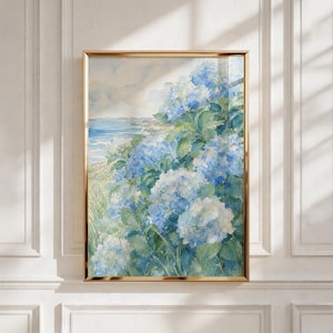 May include: A framed watercolor painting depicting a coastal scene with large clusters of blue and white hydrangea flowers in the foreground, set against a backdrop of a calm ocean, a sandy shoreline, and a soft, hazy sky in shades of blue and cream.