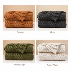 May include: Four folded knitted blankets in orange, grey, army green, and beige white. Each blanket is stacked on top of another. The text "Orange", "Grey", "Army Green", and "Beige White" are below each respective blanket.