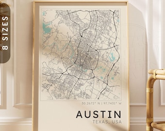 May include: A vertical wall art print featuring a detailed black and white street map of Austin, Texas, with light blue water features. The text reads 30.2672 N | 97.7431 W, AUSTIN, and TEXAS, USA, displayed in a clean, bold, sans-serif font.