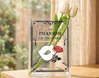 Vaso em formato de livro inspirado em O Fantasma da Ópera, em acrílico; Vaso em formato de máscara de teatro; Vaso com desenho de livro; Decoração para teatro musical; Presente personalizado para amantes de livros.