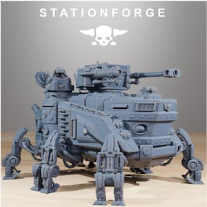May include: A grey resin miniature of a multi-legged armoured combat vehicle with a turret-mounted cannon and a small figure in a hatch. The text STATIONFORGE and a skull logo are visible at the top of this detailed sci-fi tabletop gaming model.