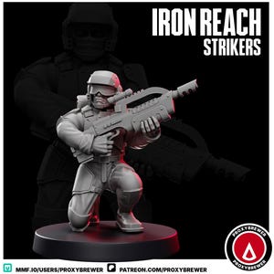 May include: A gray miniature figurine of a soldier kneeling and holding a large futuristic rifle. The figurine is wearing a helmet and tactical gear. The words "IRON REACH STRIKERS" are printed in white. The figurine is on a black base.