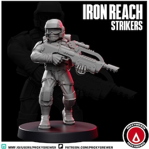 May include: A gray miniature figurine of a futuristic soldier holding a large rifle. The figure is wearing a helmet and tactical gear. The text "IRON REACH STRIKERS" is displayed above the figure. The figure is standing on a black base.