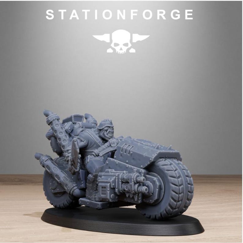 Puede incluir: Una miniatura gris de una motocicleta con un piloto, colocada sobre una base negra. La motocicleta tiene neum&aacute;ticos grandes, tubos de escape y componentes mec&aacute;nicos detallados. El texto "STATIONFORGE" y un logotipo de calavera est&aacute;n en la parte superior.
