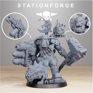 May include: A gray, detailed miniature figure of an orc warrior, holding a large gun and a hammer. The figure is accompanied by a small creature and a skull logo. The text "STATIONFORGE" is at the top. This is a miniature figure for tabletop gaming.