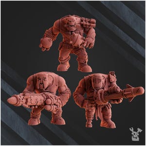 May include: Three brown miniature figures of Orc-like characters, each with distinct weaponry and armor. One figure stands with a large multi-barreled gun, another crouches with a cannon, and the third holds a rocket launcher. The figures are detailed and stylized.