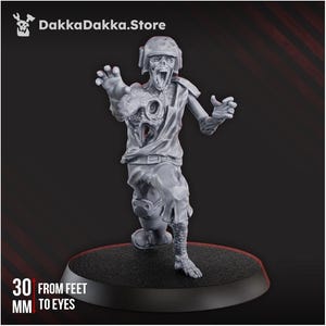 May include: A gray, detailed miniature zombie figure, wearing a helmet and tattered clothing, with arms outstretched. The figure is mounted on a black base. Text on the base reads "30 MM FROM FEET TO EYES". The DakkaDakka.Store logo is in the upper left corner.
