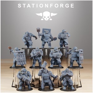 May include: A set of grey miniature figurines depicting armoured characters, some with weapons and shields. The figures are displayed on a tiered platform. The text "STATIONFORGE" is at the top of the image, along with a skull logo.