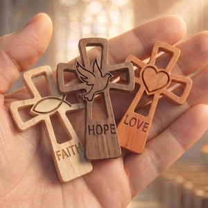 May include: Three wooden crosses featuring cut-out designs and engraved text. The light wood cross displays a fish symbol and the word FAITH. The dark wood cross shows a dove and the word HOPE. The medium wood cross features a heart and the word LOVE.