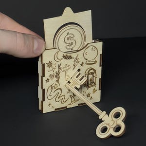 Truco de magia casero: Crea la ilusión de una llave a través de una moneda (archivos de corte láser incluidos)