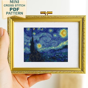 May include: A mini cross stitch PDF pattern featuring a pixelated interpretation of a starry night sky with a dark cypress tree and a bright yellow moon, displayed in a rectangular gold frame with the text MINI CROSS STITCH PDF PATTERN.