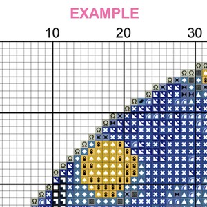 May include: A cross-stitch pattern with a grid of squares, featuring a design in shades of blue, yellow, and white. The word "EXAMPLE" is written in pink at the top. The pattern is partially completed, showing the beginning of a design.