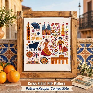 May include: A cross stitch pattern featuring Spanish cultural icons including a bull, a dancer, a matador, and architectural landmarks. The design is displayed in a wooden frame with the word SPAIN printed in the center among colorful floral motifs.