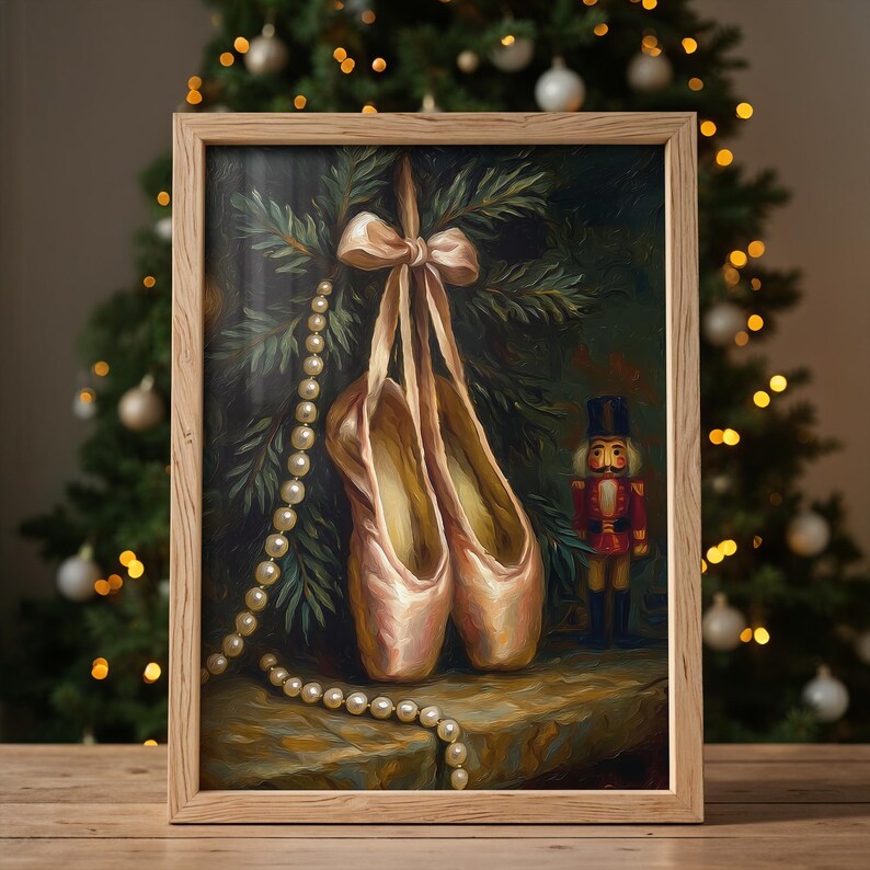 May include: A framed painting depicts a pair of pink ballet pointe shoes hanging from a bow, with a pearl necklace draped nearby. A toy nutcracker stands to the right. The background features a Christmas tree.