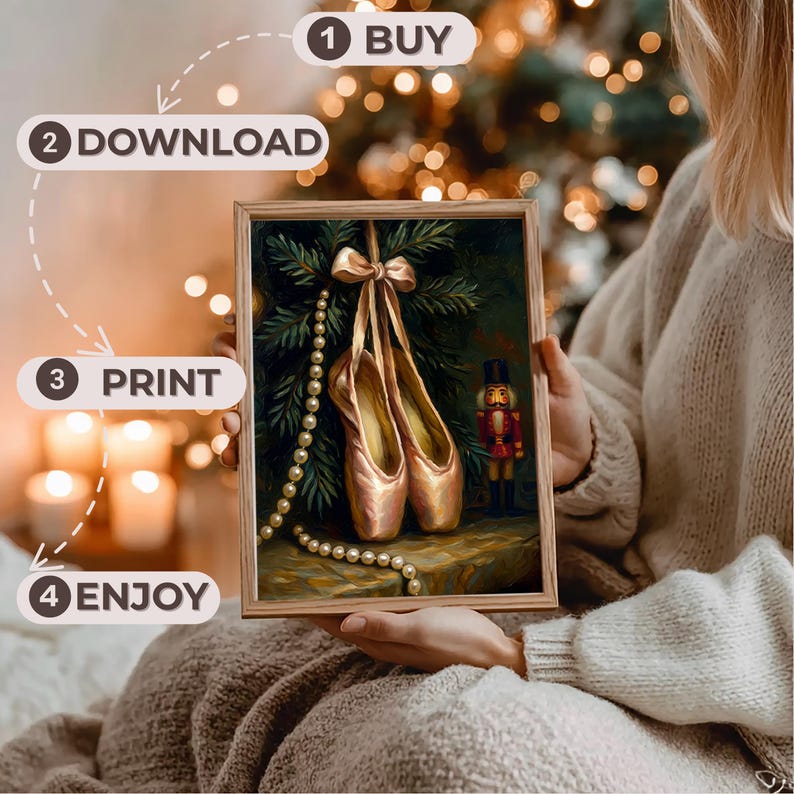 May include: A framed print featuring a still life of ballet pointe shoes, a pearl necklace, and a nutcracker. The shoes are a soft pink with gold accents, hanging from a bow. The background includes a Christmas tree and the text "BUY, DOWNLOAD, PRINT, ENJOY."