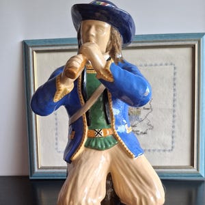 Porquier Beau, 35cm tall, depicting a young bell ringer, Quimper earthenware circa 1913-1922, a rare possible pair