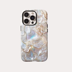 May include: A smartphone case with a pearlescent, swirling design in shades of white, cream, and gold. The case has a glossy finish and a black camera module. The overall aesthetic is elegant and luxurious.