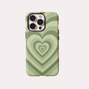 May include: A green phone case featuring a repeating heart design in varying shades of green. The case has a black camera lens border and black side buttons. The heart pattern creates a layered, concentric effect.