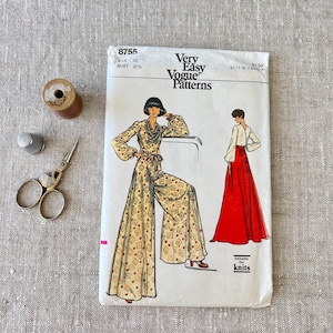 May include: A vintage Very Easy Vogue Patterns sewing pattern, size 10, featuring a jumpsuit and skirt design. The image includes a spool of thread, thimble, and scissors.