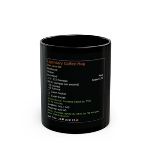 May include: A black ceramic coffee mug with the text "Legendary Coffee Mug" and game stats printed on the side. The mug has a cylindrical shape and a glossy finish. The text includes "Item Level 80" and "Mace Speed 3.70".