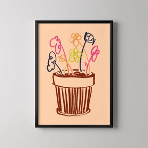 May include: A framed art print featuring a whimsical illustration of flowers in a pot. The flowers are depicted with colorful, loose lines in pink, blue, yellow, and green. The pot is brown with vertical lines, set against a peach background.