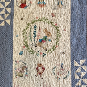 May include: A set of three ceramic mugs with a speckled, matte finish. The mugs are in shades of cream, light gray, and dark gray. Each mug has a simple, minimalist design and a rounded handle.