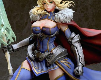 May include: A detailed figurine of a female warrior in a blue and gold outfit, complete with silver armor and a red cape. She has blonde hair, a crown, and is holding a green sword. The figure has a determined expression.