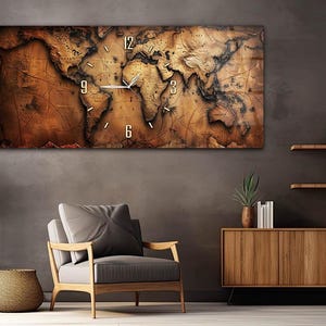 May include: A large rectangular wall clock with a world map design. The clock face features a vintage-style map in shades of brown and tan, with white clock hands and numerals. The clock is mounted on a dark gray wall above a chair and wooden cabinet.