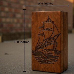 Nautical-themed wooden urn box with a beautifully engraved ship design. Made from premium hardwood with a smooth polished surface. A meaningful memorial piece offering customization for name, date, or message engraving to honor your loved one with respect.