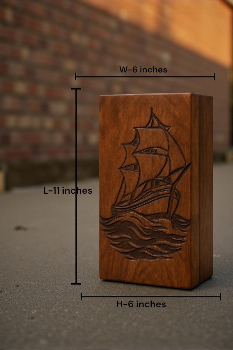 Nautical-themed wooden urn box with a beautifully engraved ship design. Made from premium hardwood with a smooth polished surface. A meaningful memorial piece offering customization for name, date, or message engraving to honor your loved one with respect.