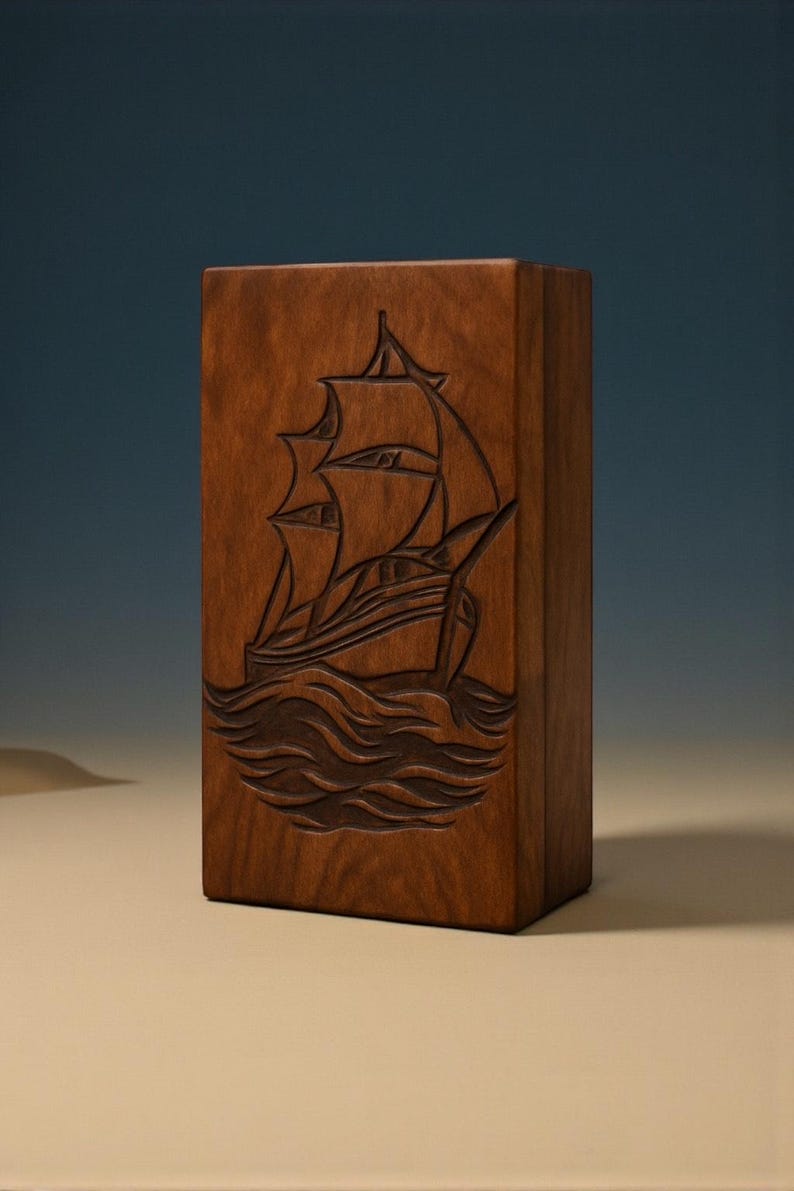 Beautifully engraved wooden urn box with a nautical sailboat design. The smooth finish and deep carving make it an ideal memorial keepsake. Designed to securely hold ashes and customizable with personal details to create a heartfelt tribute.
