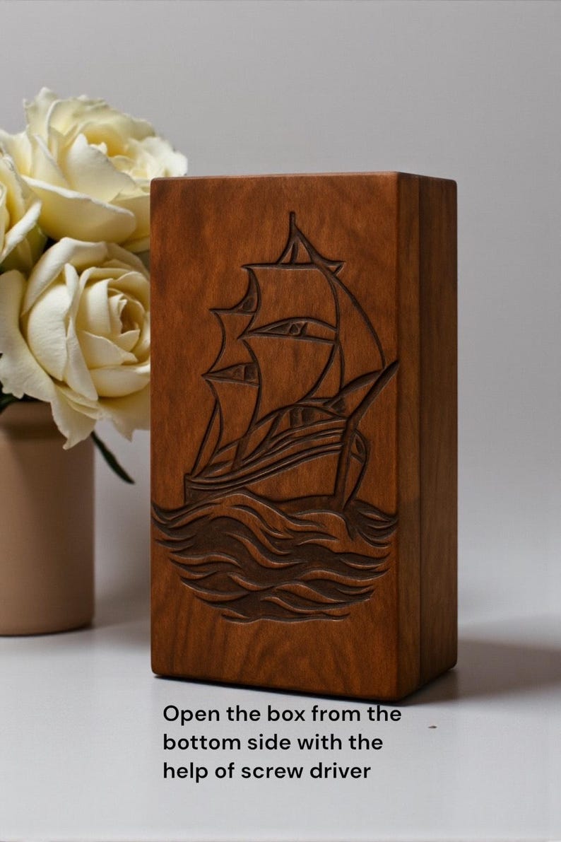 Solid wood engraved urn box with a symbolic sailing ship artwork, representing journey and serenity. Carefully crafted with secure bottom closure for safe ashes storage. Perfect for nautical-themed memorials, ocean lovers, and personalized remembrance.