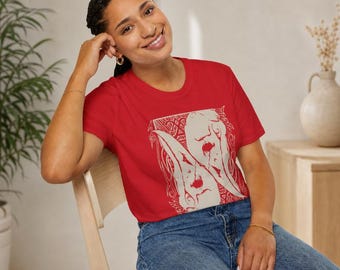 May include: A bright red short-sleeved t-shirt featuring a large, cream-colored graphic print on the front. The design depicts two stylized, elongated skull-like shapes surrounded by intricate, geometric, and linear patterns in a rectangular frame.